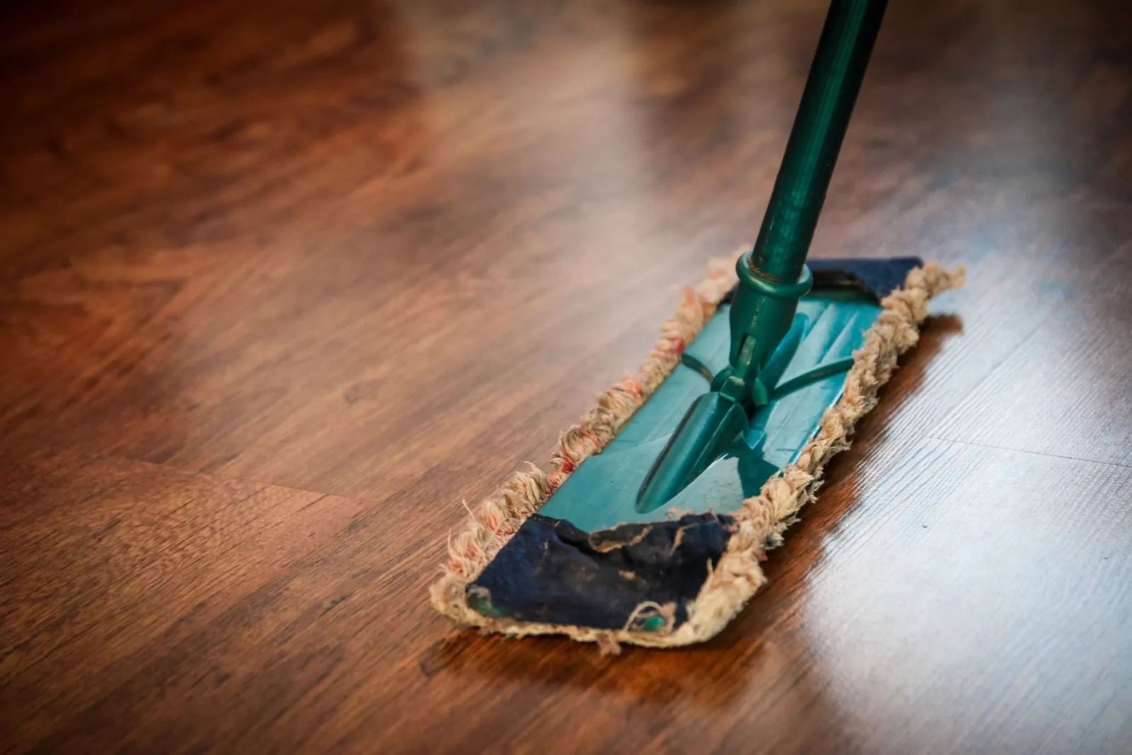 Microfiber dust mop gliding across a polished hard floor