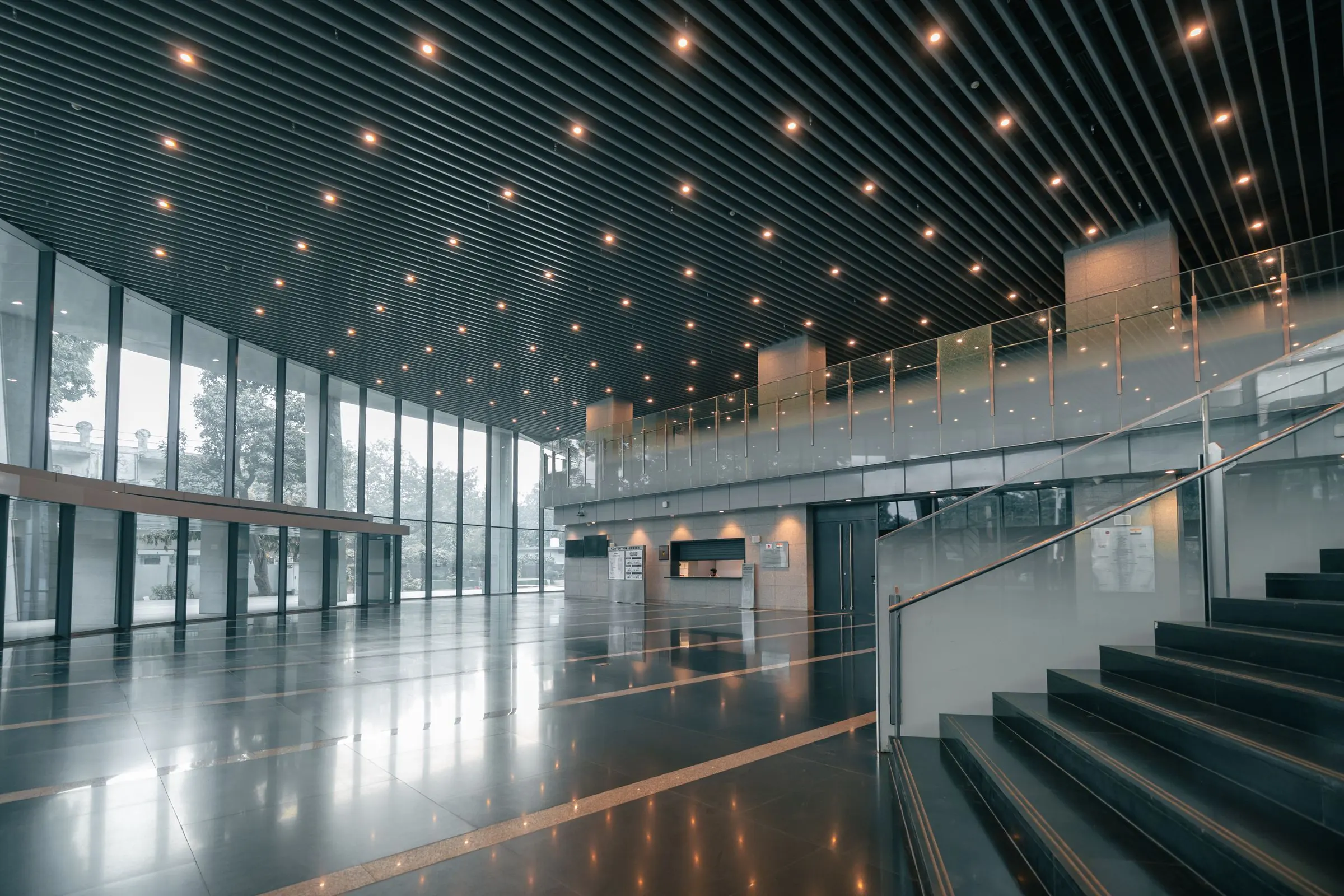 Polished floors and glass in a spotless commercial building lobby maintained by a janitorial crew