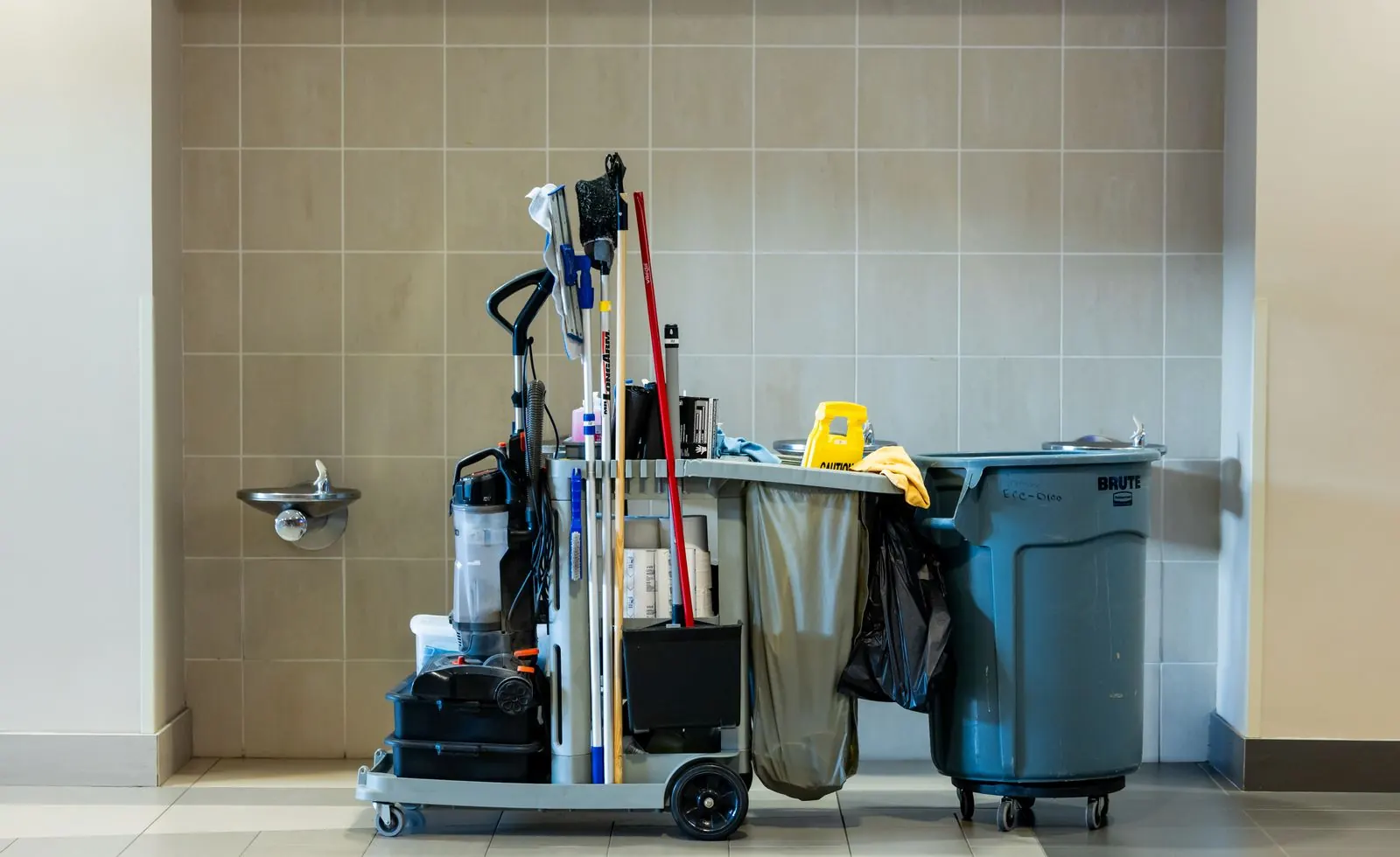 Janitorial cart in a clean commercial restroom