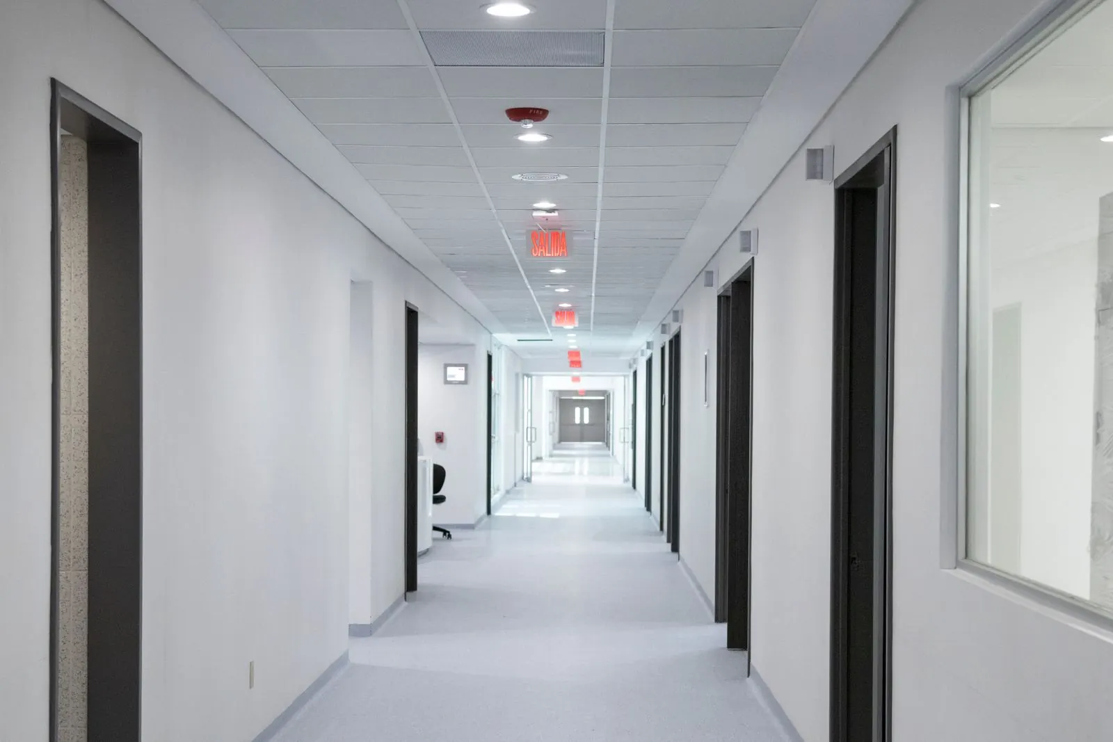 Clean office corridor with polished floors and freshly wiped doors