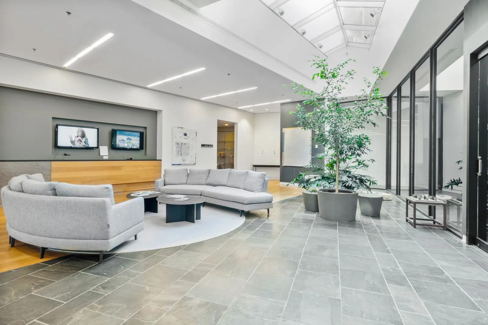 Bright commercial building lobby and common area with polished tile floor