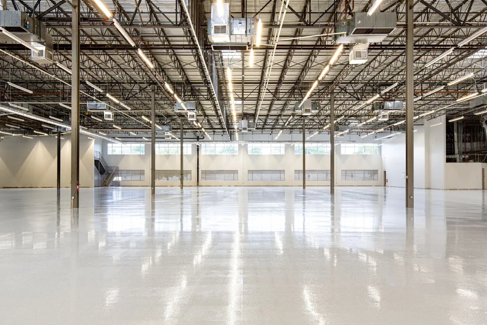 Large warehouse with a freshly cleaned, reflective concrete floor